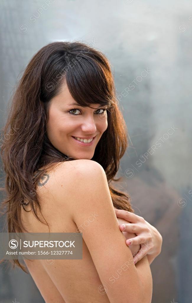 Nude Caucasian Woman Looking Over Shoulder And Smiling At Camera