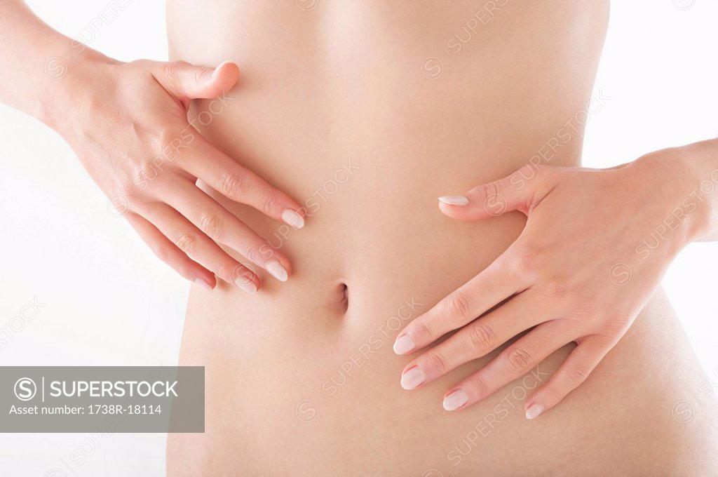 Mid Section View Of A Naked Woman Touching Her Abdomen Superstock