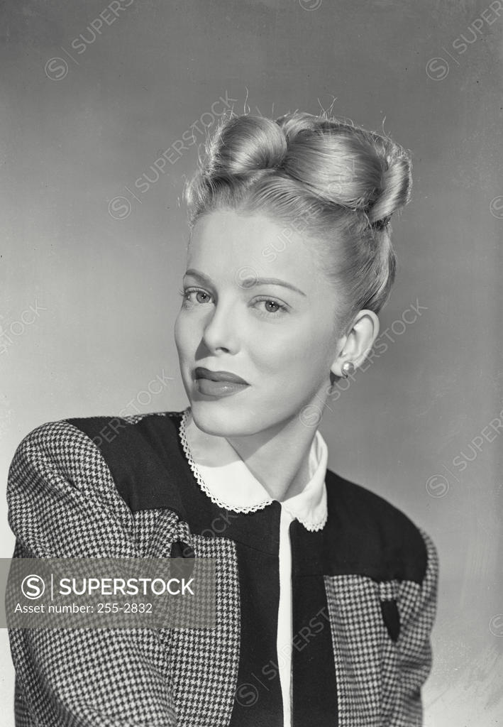 Woman With Blonde Hair In Up Style And Houndstooth Blouse SuperStock