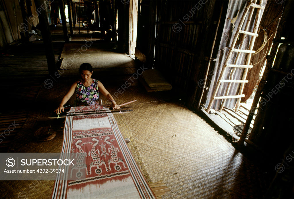 Iban Dayak Woman Weaving An Ikat Cloth Sarawak Malaysia SuperStock