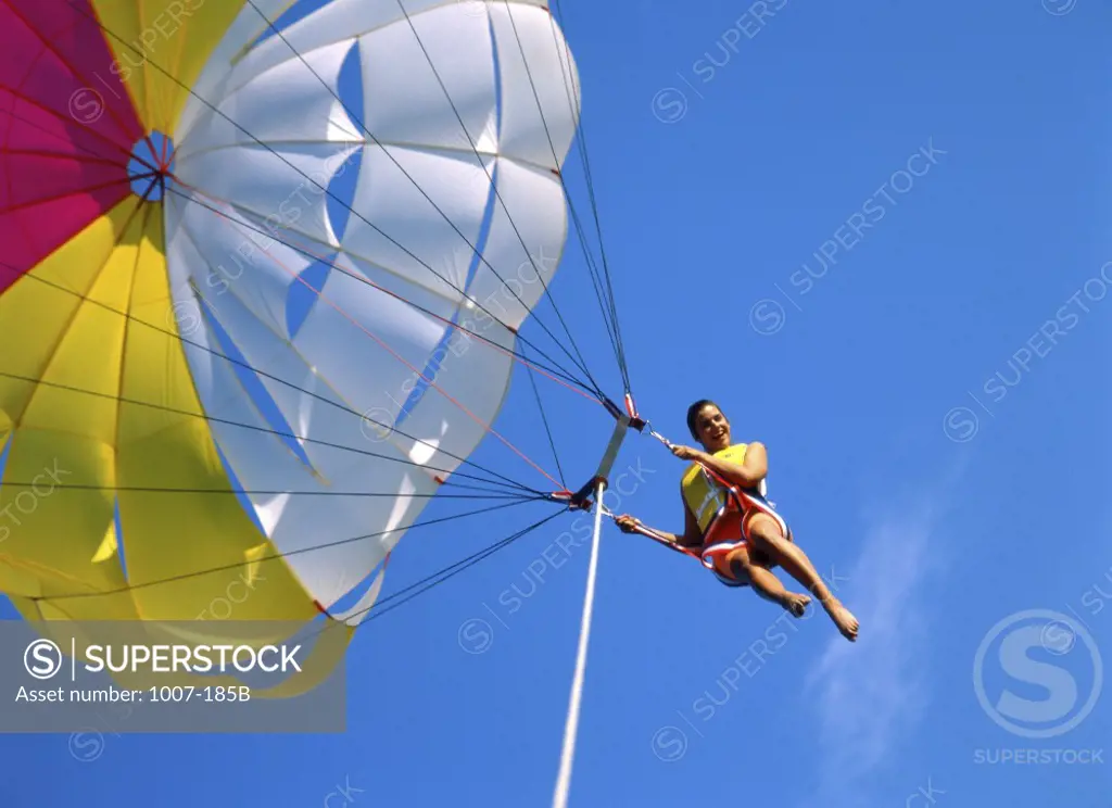 Low angle view of a young woman parasailing