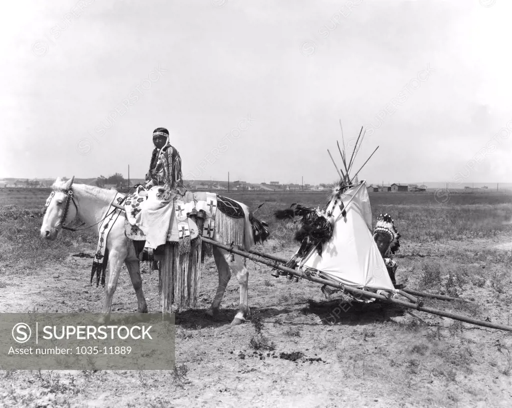 Montana:  1926. A Flathead Native American pulls her children on a travois on her way to the settlement in Montana where they will depart for the Chicago Rodeo.There they will pitch their camp in Grant Park and the  braves and squaws wil engage in tribal contests of skill and horsemanship.