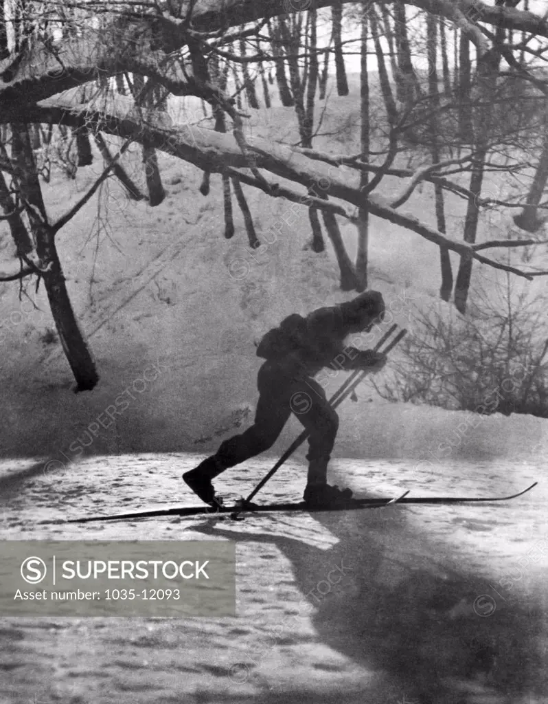 Moscow, Russia:  c. 1930. A cross country skier skiing by moonlight.