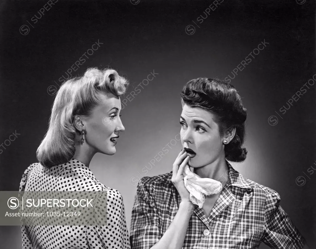 United States:  c. 1956. A woman expresses shock and surprise at what her friend has just said.