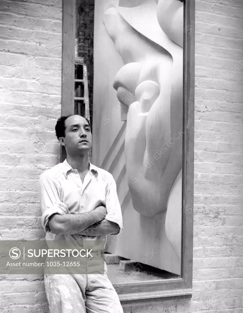 New York, New York:  1940 Isamu Noguchi with a reflection of the Associated Press Building Plaque, which was carved in plaster and cast in stainless steel - at that time the largest-ever stainless steel casting.  It is still installed in Rockefeller Center.