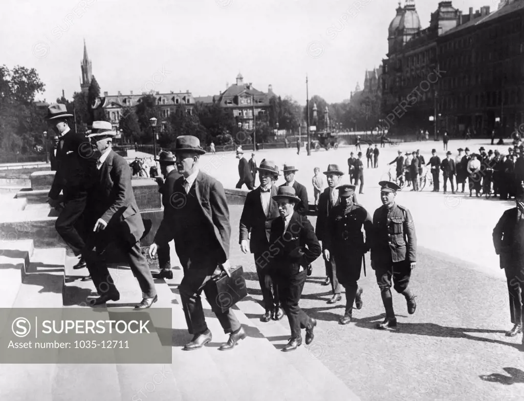 Leipzig, Germany:  June 1, 1921 Detective Inspector Collins of Scotland Yard (with briefcase) bringing to the court British witnesses who testified to crimes and atrocities commited by the Germans at the War Guilt Trial at Leipzig.