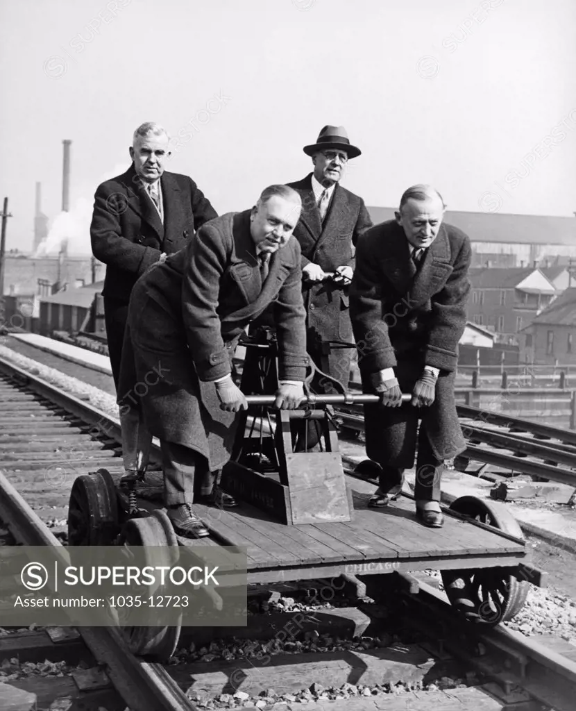 Chicago, Illinois:   March 5, 1930 Executives celebrate the joining of New York and Chicago by the longest stretch of the heaviest rail in the world.