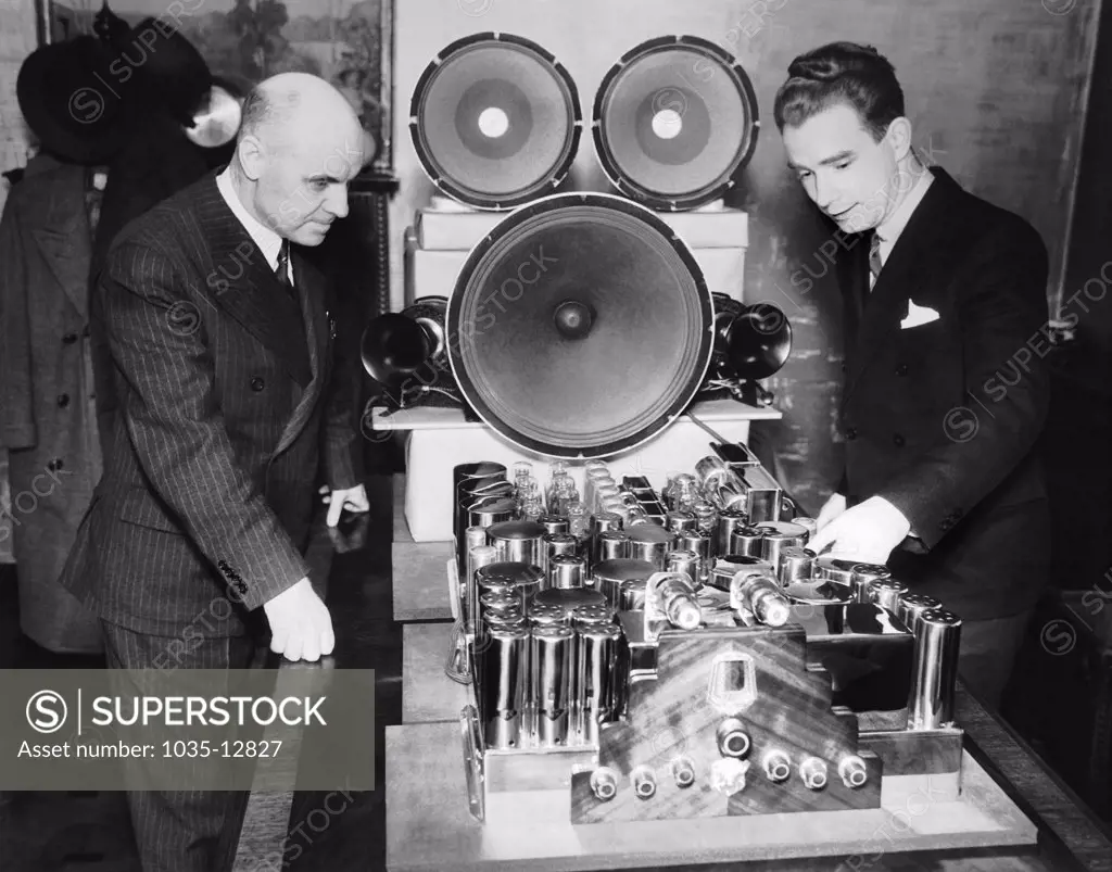 Chicago, Illinois:  1936 Designer E. H. Scott  and Murry G. Clay, chief engineer at Scott Radio Laboratories, inspect the new 40 tube Scott All-Wave Receiver, which is the largest and most complete radio ever built for home use.