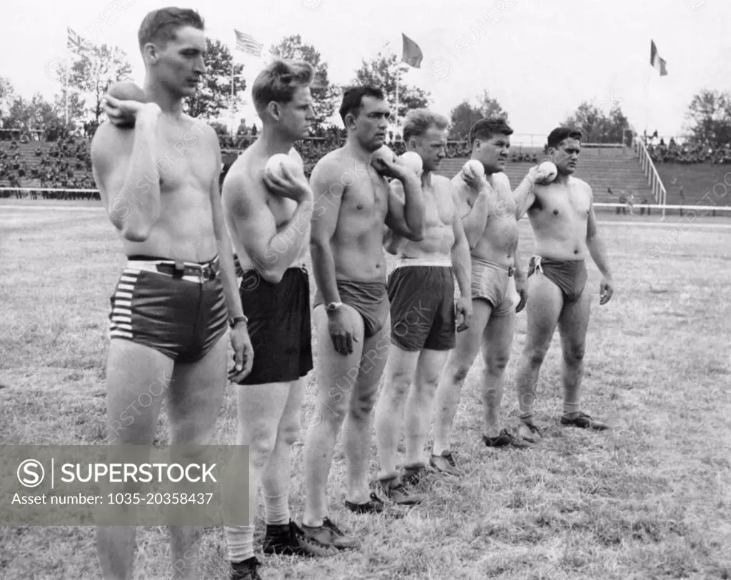 Dusseldorf, Germany:  June 15, 1945 Members of the Army's 94th Division line up for the shot put event at the track and field meet being held at the former Adolph Hitler Sport Platz.