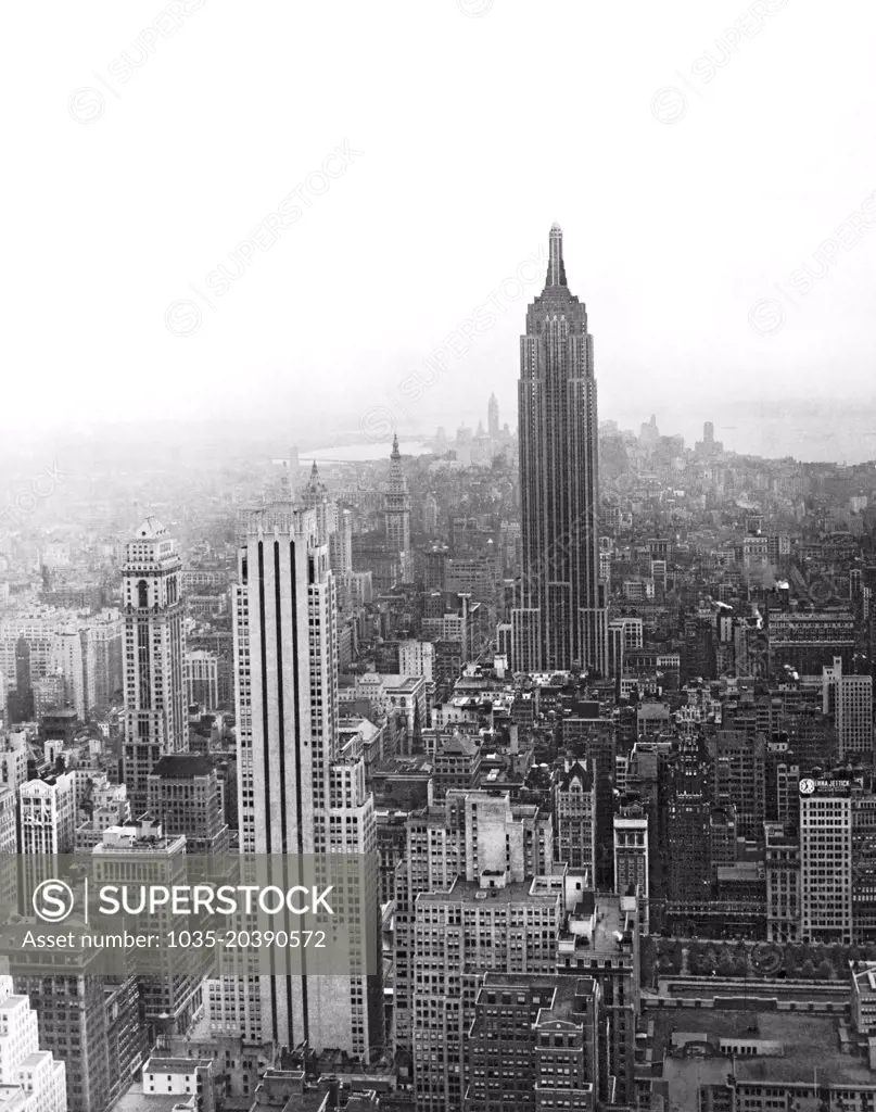 New York, New York:  c. 1939 The tallest buidling in the world, the Empire State Building, towers over midtown Manhattan. Finished in 1932, the building will retain its status as the tallest building in the world until the building of the World Trade Centers in 1972