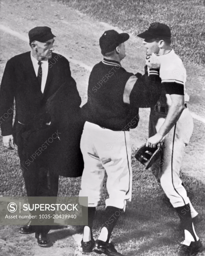 Baltimore, Maryland:  May, 1963 Baltimore first baseman JIm Gentile gets collared by his manager Billy Hitchcock as he charged towards umpire Ed Runge after being ejected from the game.