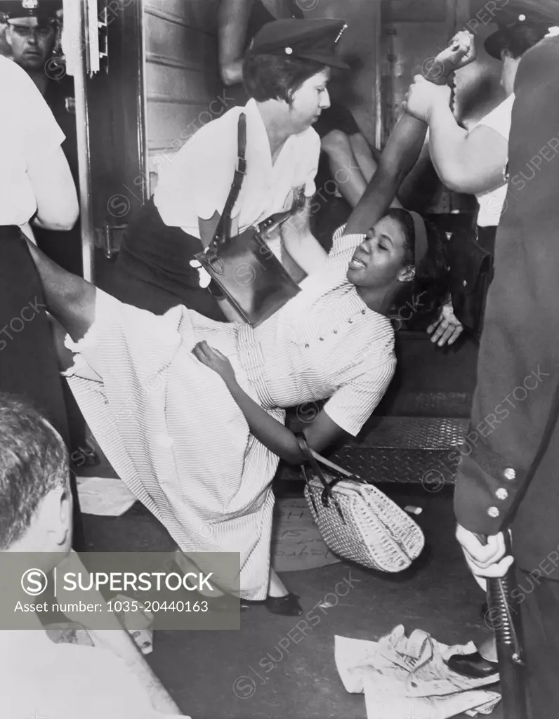 New York, New York:  1963 An African American woman being carried to police patrol wagon during a demonstration in Brooklyn.