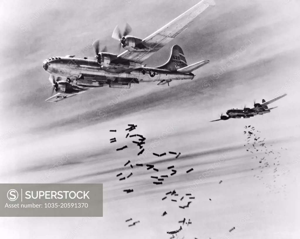 Burma:  February 28, 1945 Bombs cascade from the bomb bay doors of B-29 Superfortresses during a raid on the Japanese supply depots near the Mingaladon Air Field.