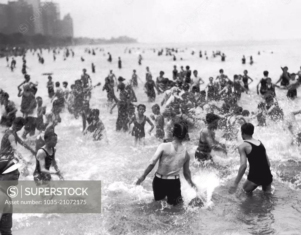 Chicago, Illinois:  July 3, 1928 A water fight on a hot day at the Oak Street Beach which is the most popular beach for the near north siders.