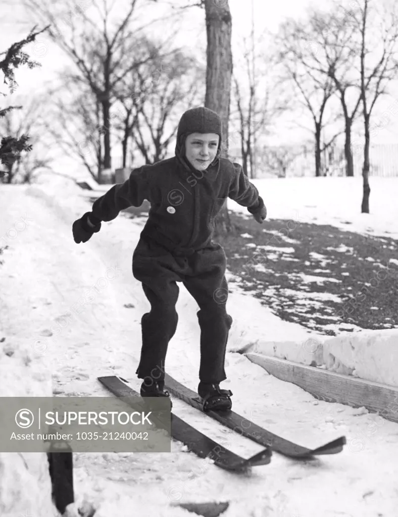 Highland Park, Illinois:  c. 1928 A young skier shows off her form on a jump at the Exmoor Country Club.