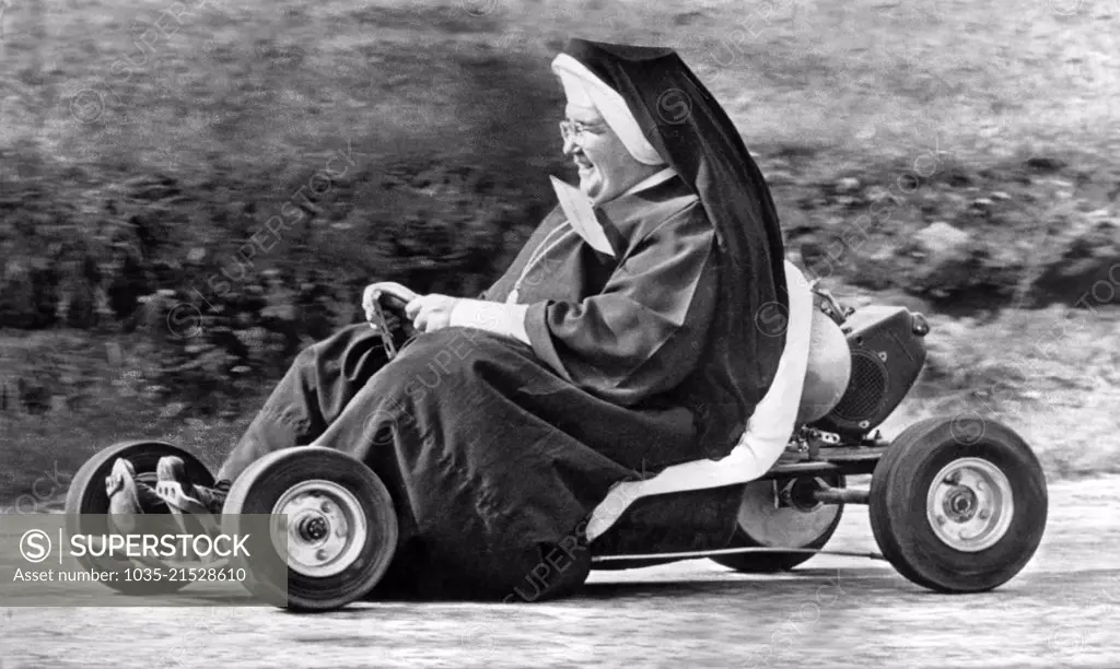 Akron, Ohio: October 10. 1962. Sister John Bosco of the St. Sebastian School  in Akron having fun tooling around a go-kart track.