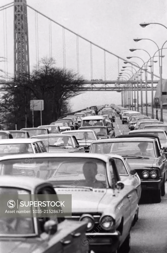 New York, New York:   May, 1966 Early morning rush hour traffic on the West Side Highway with the George Washington Bridge in the background.