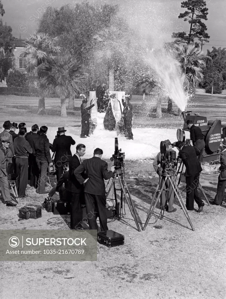 Los Angeles, California: c. January, 1938  Los Angeles Snow Sports Carnival Queen Frances Gilmore is crowned in Lafayette Park with the aid of a studio snow making machine.