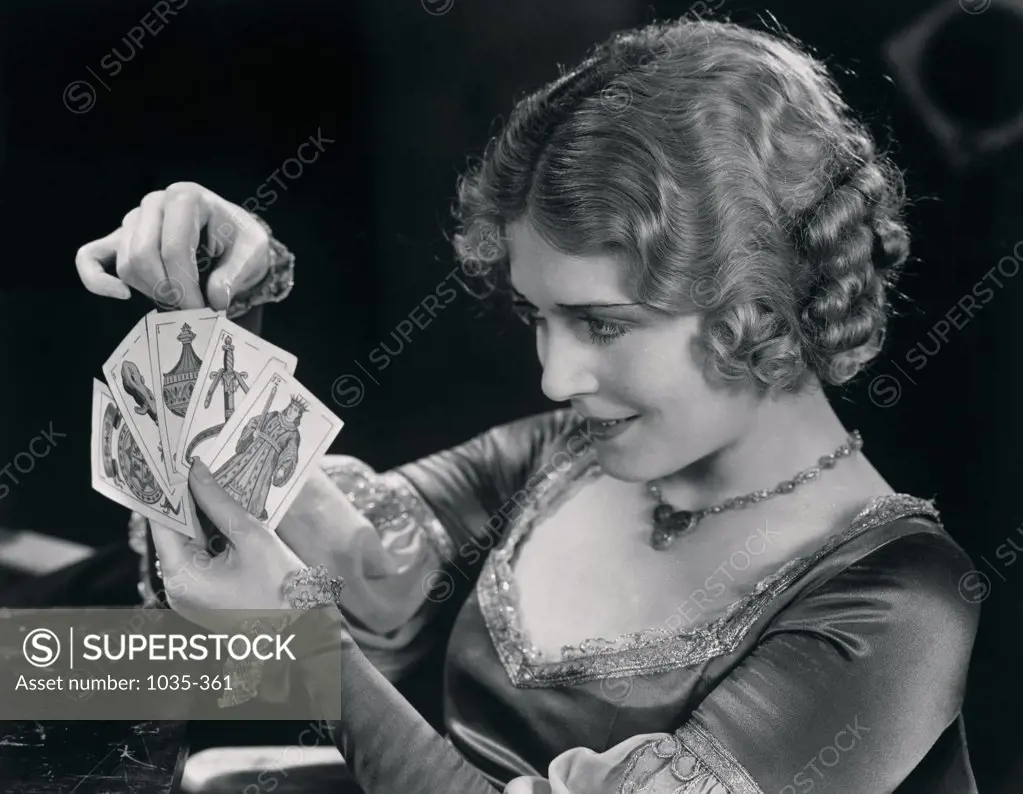 Close-up of a young woman holding tarot cards