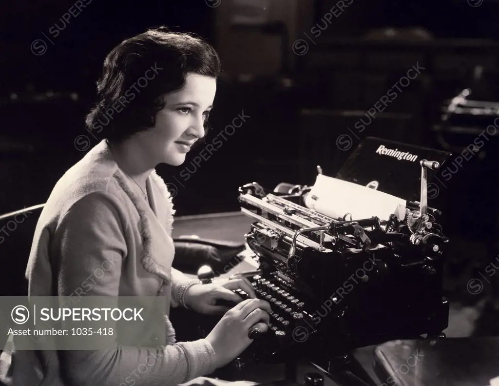 Close-up of a secretary using typewriter