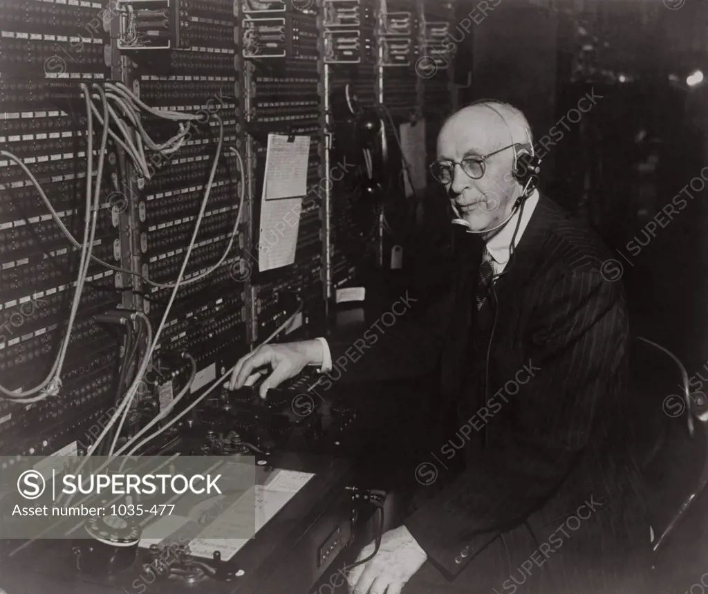 Side profile of a senior man operating a telephone switchboard