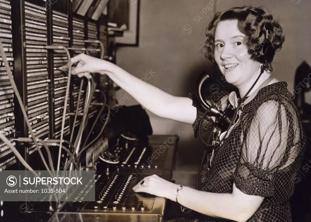 Side profile of a mature woman operating a telephone switchboard, 1936