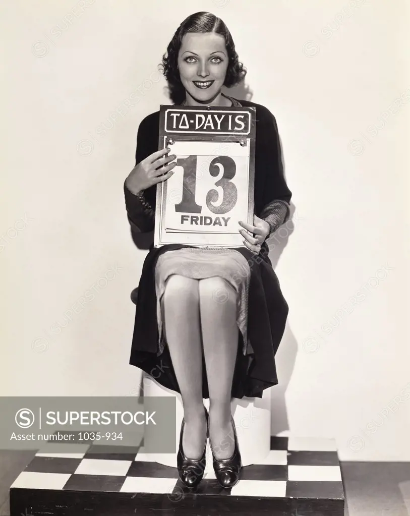 Portrait of a young woman holding a calendar