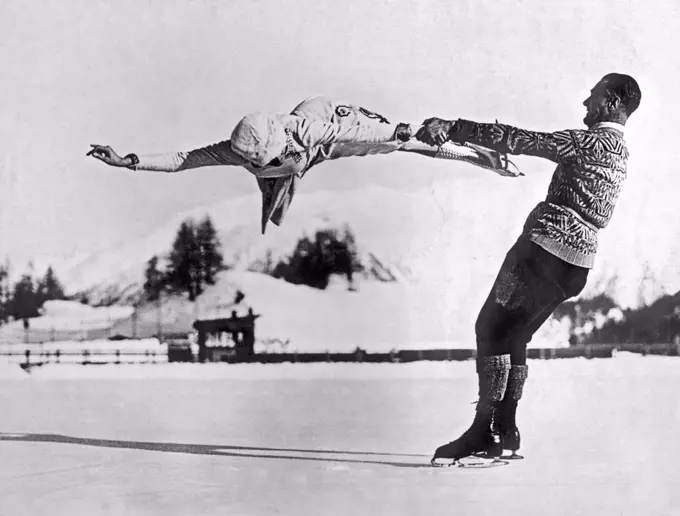 St. Moritz, Switzerland:  c. 1935. World-renowned New York figure skaters Freda Whitaker and Phil Taylor show some amazing acrobatics as they prepare for the next Winter Olympics.