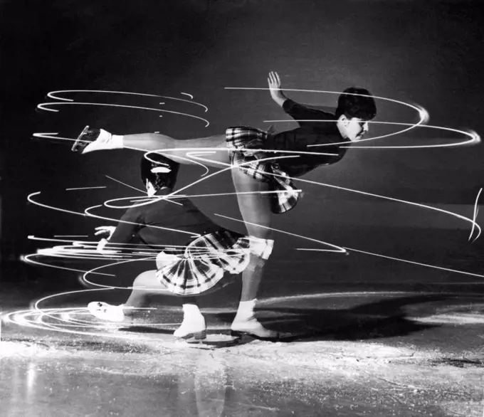 Toronto, Canada:  1962. Petra Burke, (1946-), top contender in this season's Canadian, North American, and world championships, shows how dazzling and dizzying a skater's spins can be. With a light attached to her right wrist and left foot, Miss Burke shows the moves of a sit spin and a camel spin.