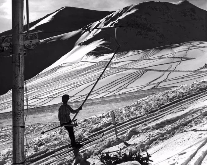 Jasper National Park, Alberta, Canada:   c. 1959'  A skier gazes at the trails made by previous adventurers on the slopes at Jasper National Park, a paradise for winter, spring, and early summer skiing.