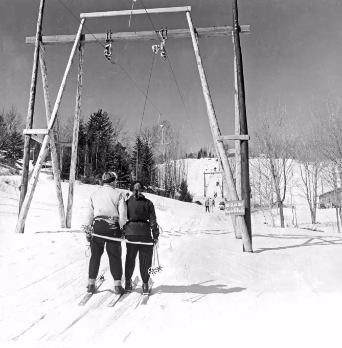 Montreal, Quebec, Canada:  c. 1951. The T-Bar ski lift at the Laurentian Mountains ski resort pulls skiers slowly up the mountain.