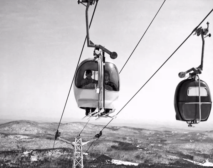 Mount Snow, Vermont:  c. 1962. The small, enclosed, 2 person ski lift moves up the face of Mount Snow.