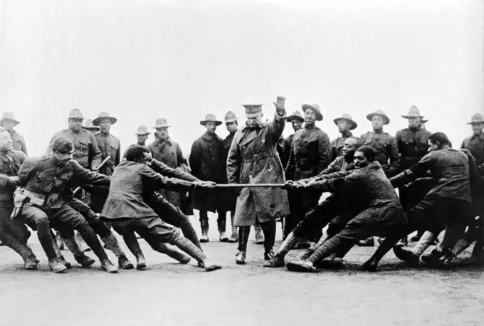 United States:  April 17, 1918 Two groups of African American soldiers having a tug of war contest.