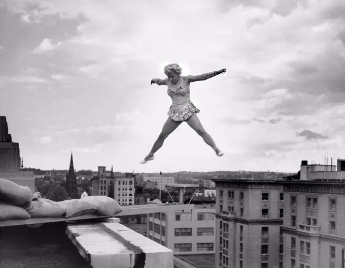 Washington, D.C.:  June 5, 1954 Betty Fox performs her acrobatic routine on a tiny platform extended from the roof of the Ambassador Hotel. She is 100 feet above the sidewalk below.