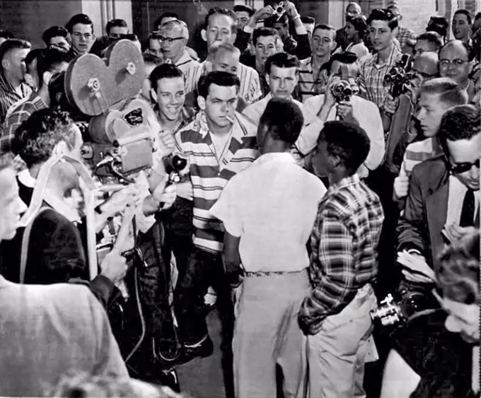 Little Rock, Arkansas: September 9, 1957. Students at the North Little Rock HIgh School  blocked the doors of the school to prevent six Negro students who had been enrolled earlier at the school from entering. The picture shows a white student daring a Negro to try and enter. Just after this picture was taken, the Negroes were shoved down a flight of stairs and out to the sidewalk.