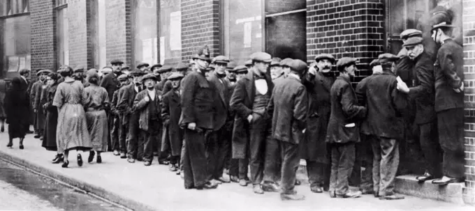 London, England:  c. 1923 Unemployed men in London standing in line at the Employment (Dole Line) Exchange.