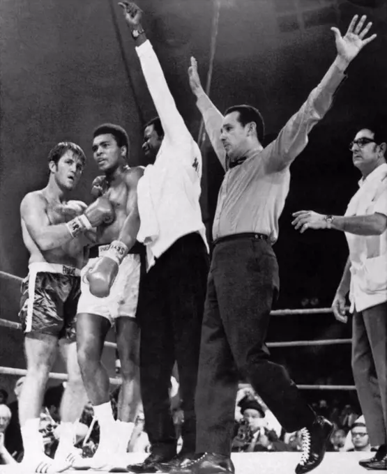 Atlanta, Georgia:  October 26, 1970. Referee Tony Perez signals the end of the fight between Muhammad Ali and Jerry Quarry. Angelo Dundee, Ali's manager, is at the right.