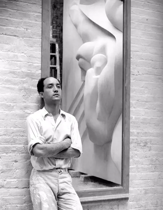 New York, New York:  1940 Isamu Noguchi with a reflection of the Associated Press Building Plaque, which was carved in plaster and cast in stainless steel - at that time the largest-ever stainless steel casting.  It is still installed in Rockefeller Center.