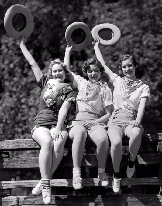 Willits, California:  1936. Three cowgirls on a corral fence are ready for the Frontier Days celebration held over the Fourth of July in Willits.