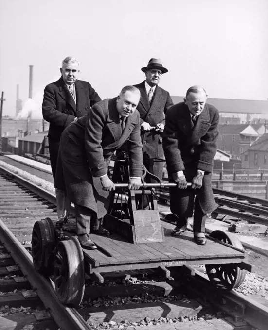 Chicago, Illinois:   March 5, 1930 Executives celebrate the joining of New York and Chicago by the longest stretch of the heaviest rail in the world.