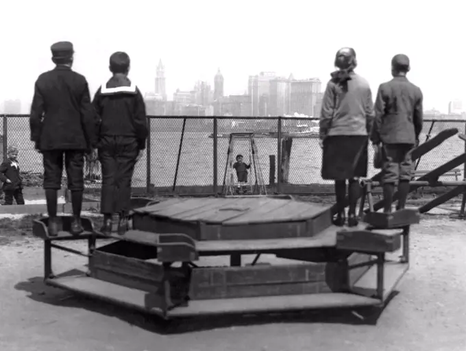 New York, New York:  c. 1913 Immigrants representing four countries, Poland, Norway, Germany, and Russia, looking from Ellis Island towards the promised land.