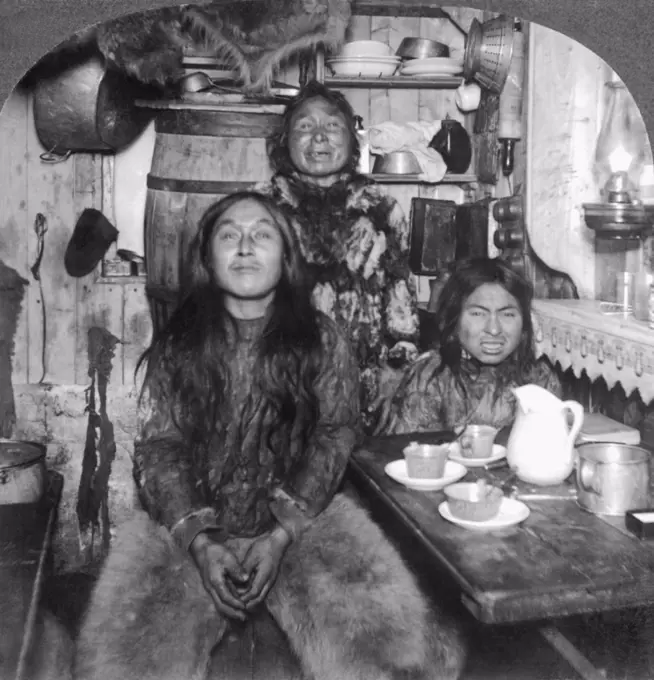 Fort Magnesia, Cape Sabine, Ellesmere Land, Canada:   c. 1900 An Eskimo family poses in its home.