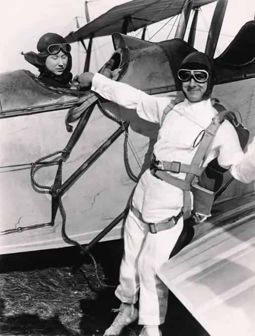 United States:  c. 1927 A man ready to parachute from a biplane.