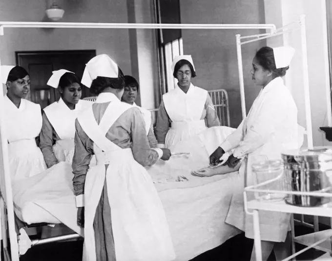 New York, New York:   c. 1929 African American student nurses at the Lincoln Training School for Nurses in the Bronx learning methods of dressing wounds.