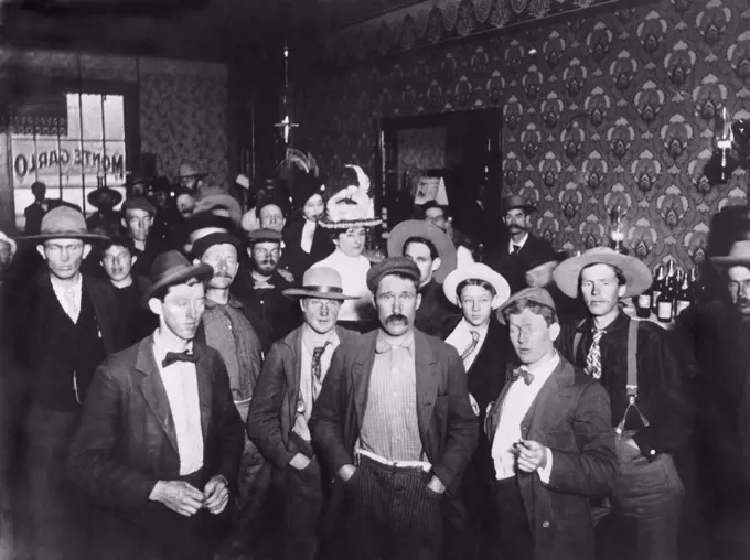 Dawson City, Yukon Territory, Canada:  c. 1898 The interior of the Monte Carlo Saloon in Dawson City with its numerous men and two women.