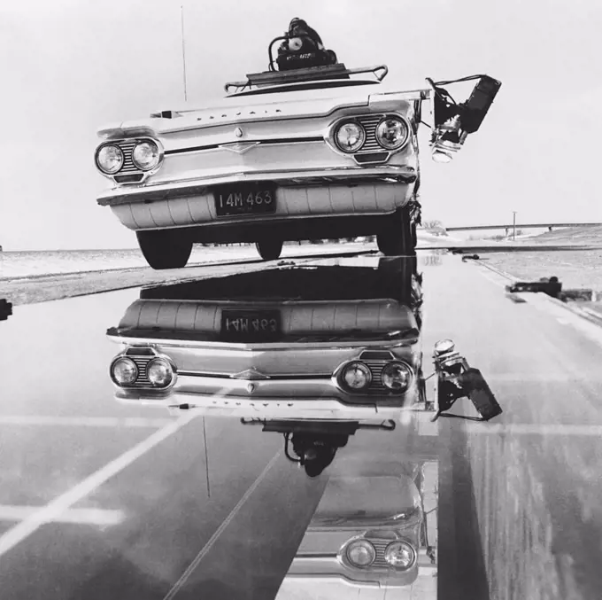 Detroit, Michigan:  May, 1964 A Corvair test car on the "glass road" at the General Motors Proving Ground. The car has photo headlamps and a camera focused on the mirror under the glass surface. The mirror reflects the tire's footprint and is photographed at 2200 frames per second at 60 mph.