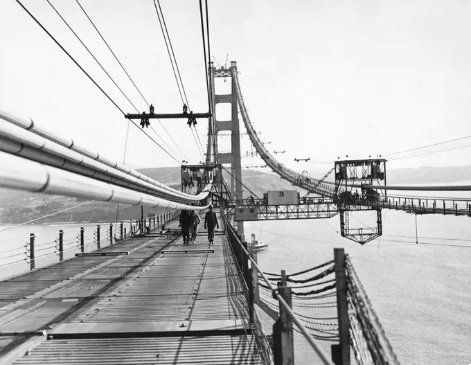 San Francisco, California:   c. 1936 Construction of the Golden Gate Bridge with a view of the catwalks being placed under the cables.