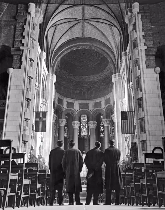 New York, New Yrok:   April, 1938. Four visitors look across the nave toward the unfinished sanctuary and choir at the Cathedral of St. John The Divine. Bishop Manning has launched a million dollar fund drive to complete the cathedral before the opening of the 1939 World's Fair.