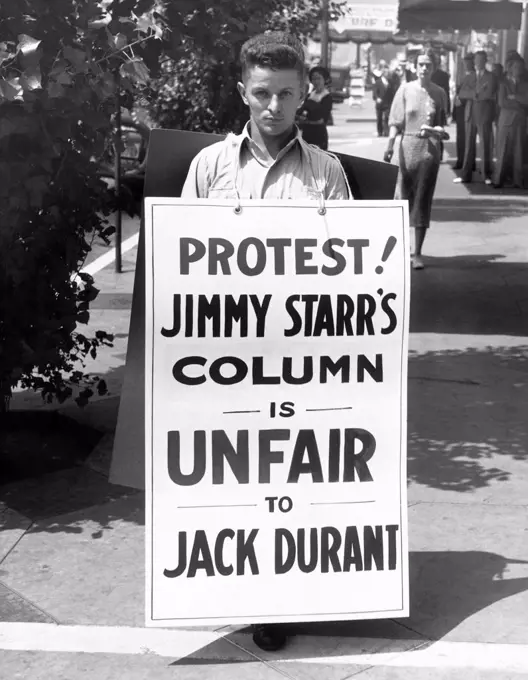 Hollywood, California:  c. 1936 Actor Jack Durant walks with a sandwich board protesting his treatment in a Jimmy Starr column.