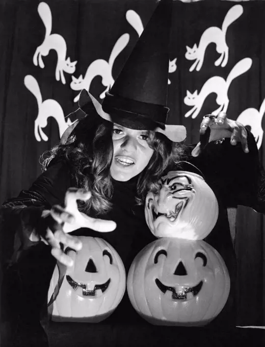 New York, New York:  1970 CBS television actress Drinda La Lumia gets into the spirit of Halloween with cats and pumpkins.